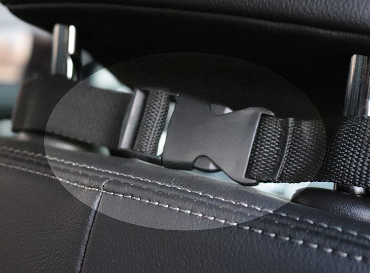 Close-up of the car seat cover strap and buckle around a headrest